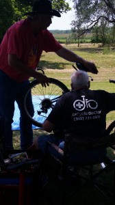 Dale Dollar of the Bicycle Doctor helps repair a bike for a youth in foster care 