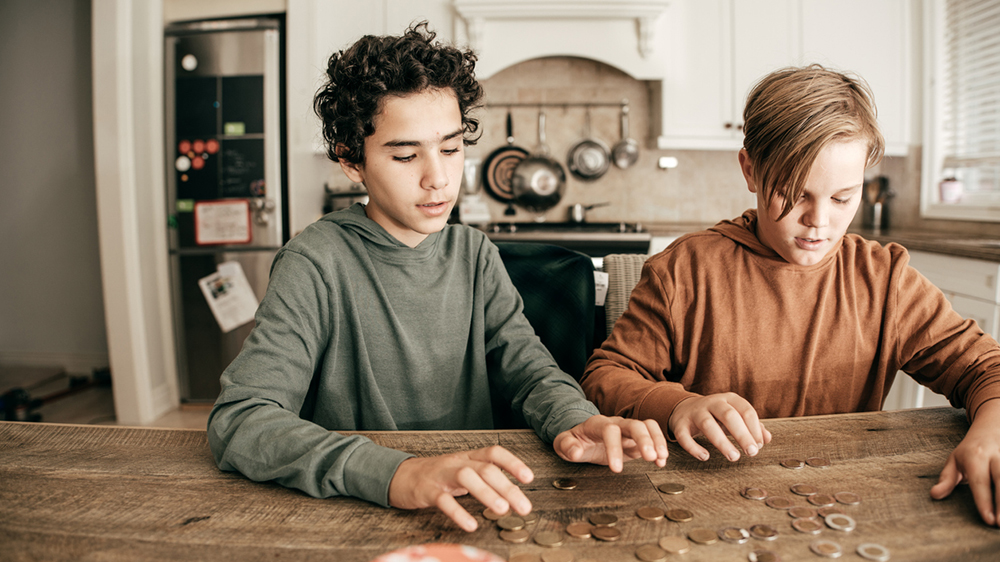 teen boys counting coins and money