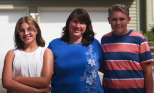 Michelle and her family pose outside in this foster care adoption success story
