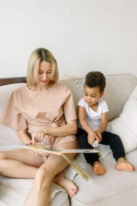 Foster parent and child reading book 